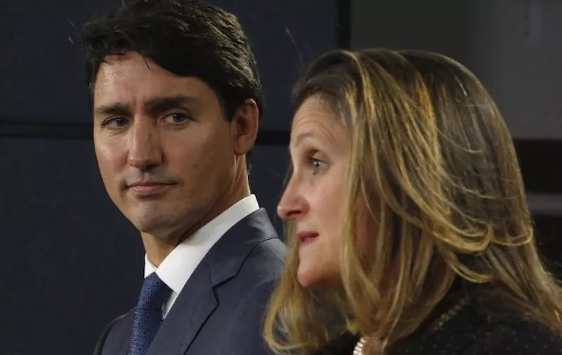 Canada's Prime Minister Justin Trudeau (L) and Minister of Foreign Affairs Chrystia Freeland (R) speak at a press conference to announce the new trade with between Canada, the United States, and Mexico in Ottawa, October 1, 2018. - Trudeau hailed a continental trade deal reached with the United States, along with Mexico, as "profoundly beneficial" to Canadians. "It is an agreement that will be profoundly beneficial for our economy, for Canadian families and for the middle class," Trudeau told a news conference hours after a new US-Mexico-Canada Agreement was reached in the eleventh-hour overnight talks. (Photo by PATRICK DOYLE / AFP)