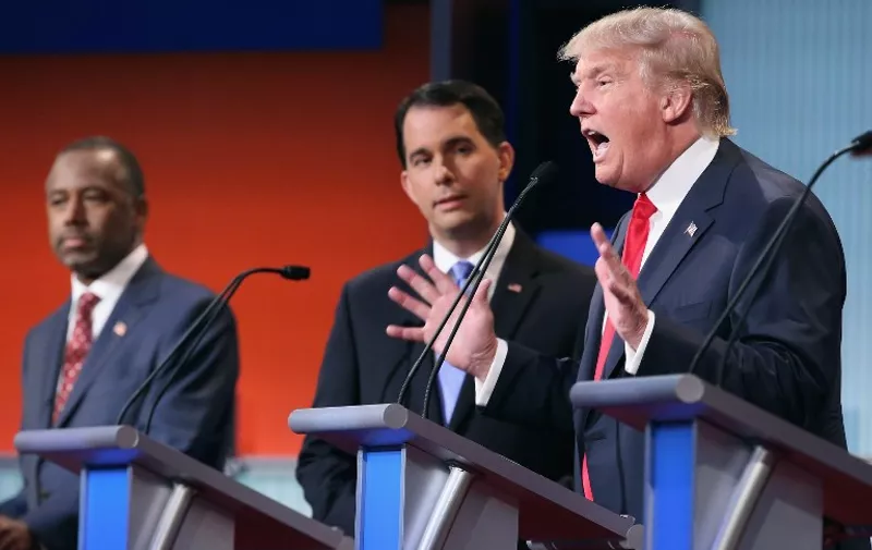 CLEVELAND, OH - AUGUST 06: Republican presidential candidates (L-R) Ben Carson, Wisconsin Gov. Scott Walker and Donald Trump participate in the first prime-time presidential debate hosted by FOX News and Facebook at the Quicken Loans Arena August 6, 2015 in Cleveland, Ohio. The top-ten GOP candidates were selected to participate in the debate based on their rank in an average of the five most recent national political polls.   Chip Somodevilla/Getty Images/AFP