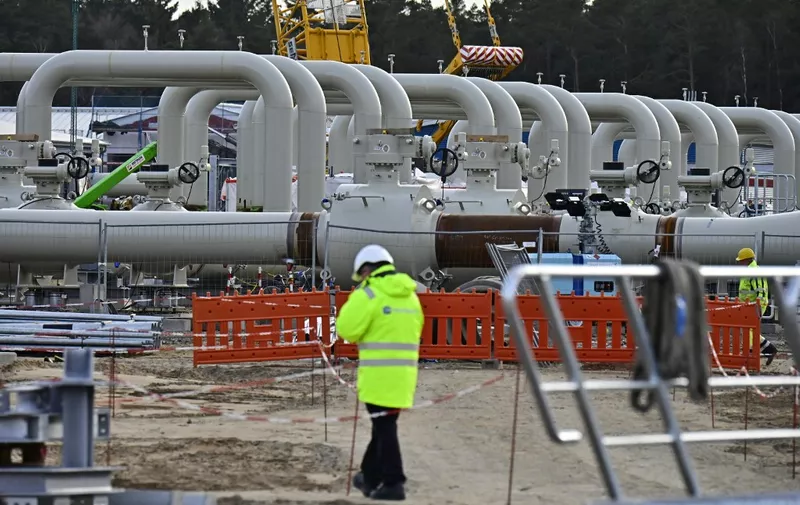 Men work at the construction site of the so-called Nord Stream 2 gas pipeline in Lubmin, northeastern Germany, on March 26, 2019. - The Nord Stream 2 pipeline will double the capacity to ship gas from Russia to Germany via the waters of Finland, Sweden and Denmark. The pipeline has faced opposition from many countries in eastern and central Europe, the United States and particularly Ukraine because it risks increasing Europe's dependence on Russian natural gas. (Photo by Tobias SCHWARZ / AFP)