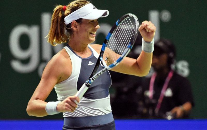 Garbine Muguruza of Spain celebrates her victory against Lucie Safarova of the Czech Republic during their women's singles round robin tennis match at the WTA Finals in Singapore on October 26, 2015. AFP PHOTO / ROSLAN RAHMAN