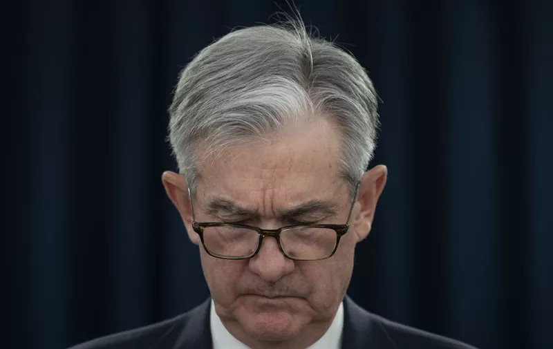 US Federal Reserve Bank Chairman Jerome Powell looks at his notes during a press conference in Washington, DC, on December 11, 2019. - Powell said Wednesday he would want to see a "significant" and "persistent" inflation rise before he would raise rates to clamp down on prices. For now, the Fed's benchmark interest rate "is appropriate and will remain appropriate" until there is a change in the outlook, he said. "In order to move rates up, I would want to see inflation that is persistent and that is significant," Powell told reporters. (Photo by Eric BARADAT / AFP)