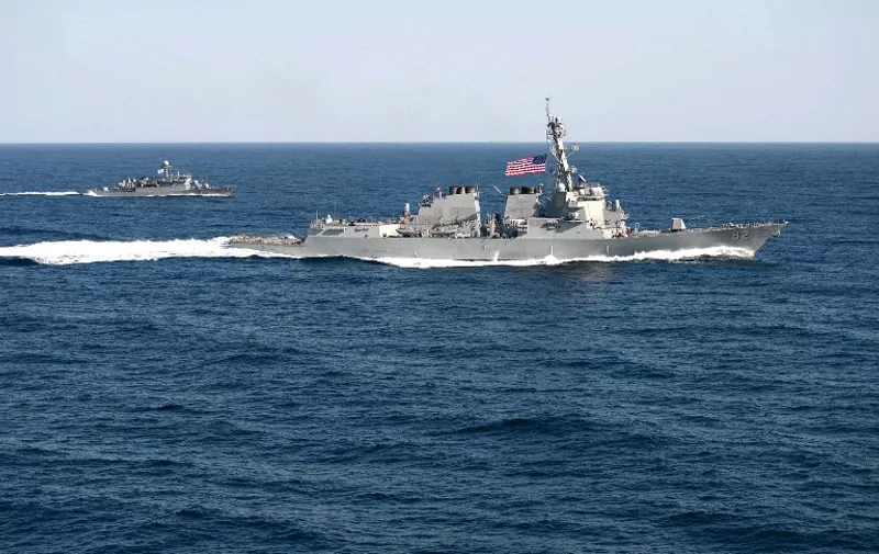 In this March 12, 2015 US Navy handout photo, the guided-missile detroyer USS Lassen (DDG 82) is underway in formation with the Republic of Korea patrol craft Sokcho (PCC 778) during exercise Foal Eagle 2015.  The United States defied China Tuesday by sending a warship close to artificial islands the rising Asian power is building in disputed waters, prompting Beijing to furiously denounce what it called a threat to its sovereignty.
The USS Lassen passed within 12 nautical miles -- the normal limit of territorial waters around natural land -- of at least one of the formations Beijing claims in the South China Sea. Chinese authorities "monitored, shadowed and warned" the guided missile destroyer in the Spratly islands, Beijing said. Washington's long-awaited move to assert freedom of navigation may escalate the dispute over the strategically vital waters, where Beijing has been transforming reefs and outcrops into artificial islands with potential military use. AFP PHOTO / HANDOUT / US NAVY / MC1 MARTIN WRIGHT     == RESTRICTED TO EDITORIAL USE / MANDATORY CREDIT: "AFP PHOTO / HANDOUT / US NAVY / MC1 MARTIN WRIGHT"/ NO MARKETING / NO ADVERTISING CAMPAIGNS / DISTRIBUTED AS A SERVICE TO CLIENTS ==