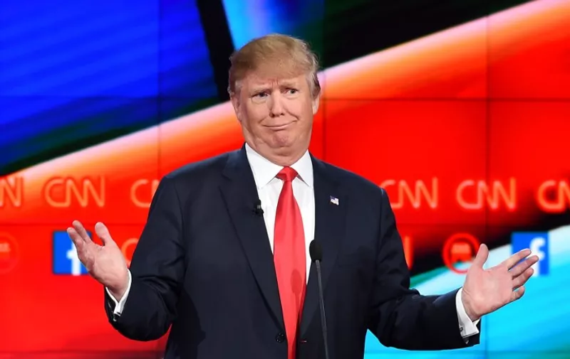 (FILES) - A file picture taken on December 15, 2015 in Las Vegas, Nevada, shows Republican presidential candidate Donald Trump during a presidential debate. Good. Bad. Stupid. When it comes to his choice of words, Donald Trump keeps it simple. So simple, in fact, that even a nine-year-old can get what the Republican White House frontrunner is saying, according to a test developed for the US Navy.  AFP PHOTO/ ROBYN BECK / AFP / ROBYN BECK