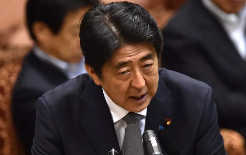 Japanese Prime Minister Shinzo Abe answers a question by an opposition lawmaker at the Upper House's budget committee session at the National Diet in Tokyo on August 24, 2015. Abe will not visit China next month as he faces parliamentary backlash over his bid to expand the role of the military. Earlier this month, Abe repeated a desire to meet Chinese President Xi Jinping in early September, but was not expected to attend a huge Beijing military show of strength to commemorate the 70th anniversary of Japan's defeat in World War II.  AFP PHOTO / Yoshikazu TSUNO