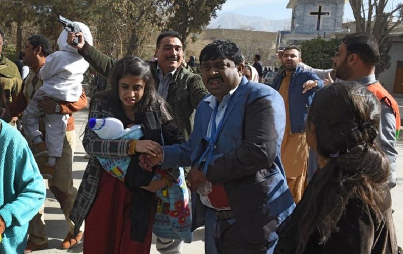 Pakistani Christians are evacuated by security personnel from a Methodist church after a suicide bomber attack during a Sunday service in Quetta on December 17, 2017.
At least five people were killed and 15 wounded when two suicide bombers attacked a church in Pakistan during a service on December 17, just over a week before Christmas, police said. The attack took place at the Methodist Church in the restive southwestern city of Quetta in Balochistan province. 
 / AFP PHOTO / BANARAS KHAN