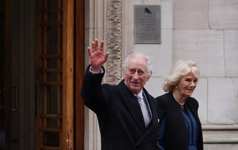 Britain's King Charles III (L) waves as he leaves, with Britain's Queen Camilla,  the London Clinic, in London, on January 29, 2024. Britain's King Charles III, 75, stayed the London Clinic following prostate surgery on January 26, 2024. (Photo by Adrian DENNIS / AFP)