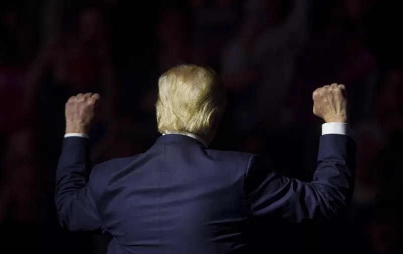 MANCHESTER, NH - NOVEMBER 07: Republican presidential candidate Donald Trump makes gestures to supporters at the end of his rally at the SNHU Arena on November 7, 2016 in Manchester, New Hampshire. With one day until the election, both candidates and their surrogates are holding campaign rallies in battleground states across the nation.   Scott Eisen/Getty Images/AFP