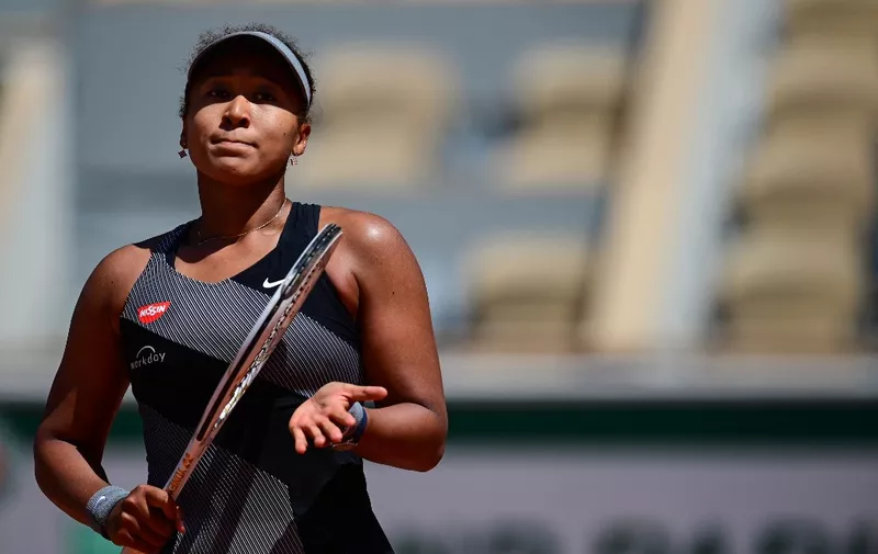 Japan's Naomi Osaka celebrates after winning against Romania's Patricia Maria Tig during their women's singles first round tennis match on Day 1 of The Roland Garros 2021 French Open tennis tournament in Paris on May 30, 2021. (Photo by MARTIN BUREAU / AFP)
