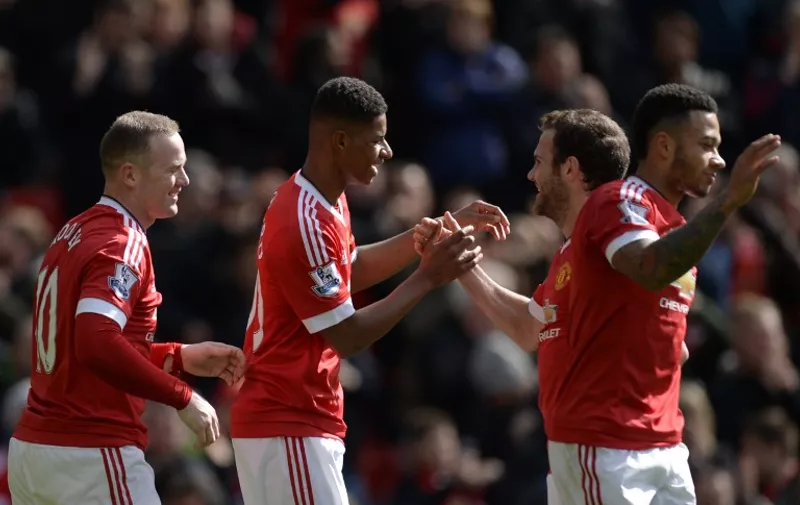 Manchester United's English striker Marcus Rashford (2R) shakes hands with Manchester United's Spanish midfielder Juan Mata (2R) after scoring the opening goal during the English Premier League football match between Manchester United and Aston Villa at Old Trafford in Manchester, north west England, on April 16, 2016. / AFP PHOTO / OLI SCARFF / RESTRICTED TO EDITORIAL USE. No use with unauthorized audio, video, data, fixture lists, club/league logos or 'live' services. Online in-match use limited to 75 images, no video emulation. No use in betting, games or single club/league/player publications.  /