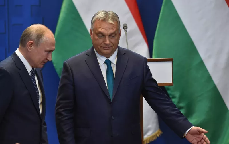 Hungarian Prime Minister Viktor Orban points the way to Russian President Vladimir Putin (L) after a press conference at the residence of the prime minister office in Budapest on October 30, 2019. - The Russian President is on brief visit to Hungary having talks with the Hungarian prime minister. (Photo by Attila KISBENEDEK / AFP)