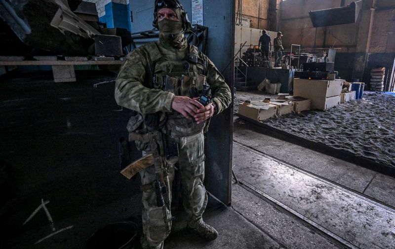 (FILES) In this file photo taken on June 14, 2022 A Russian serviceman stands guard at a private Berdyansk foundry in Berdyansk, amid the ongoing Russian military action in Ukraine. (Photo by Yuri KADOBNOV / AFP)
