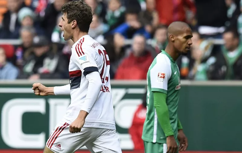 Bayern Munich's midfielder Thomas Mueller (L) celebrates after scoring during the German first division Bundesliga football match SV Werder Bremen vs FC Bayern Munich in Bremen, northern Germany, on October 17, 2015.  AFP PHOTO / TOBIAS SCHWARZ

RESTRICTIONS: DURING MATCH TIME: DFL RULES TO LIMIT THE ONLINE USAGE TO 15 PICTURES PER MATCH AND FORBIDS IMAGE SEQUENCES TO SIMULATE VIDEO. 
== RESTRICTED TO EDITORIAL USE ==
FOR FURTHER QUERIES PLEASE CONTACT DFL DIRECTLY AT + 49 69 650050.