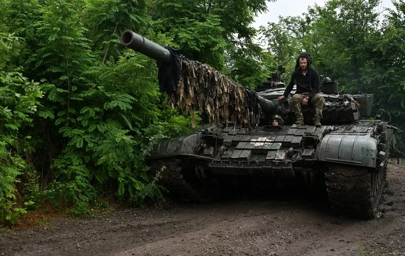 Ukrainian servicemen check their T-72 tank at a position in the Donetsk region on June 25, 2023, amid the Russian invasion of Ukraine. (Photo by Genya SAVILOV / AFP)