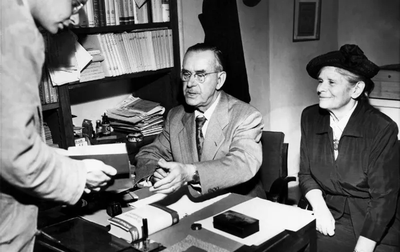 German writer Thomas Mann (C-1875-1955) autographs his book "Doctor Faustus"  (wrote in 1947) 11 May 1951 at a bookstore in Paris with his wife Katia. Mann, the Nobel Prize for Literature in 1929, wrote his early masterpiece "Buddenbrooks" in 1901, tracing the decline of a family over four generations. He produced several short stories and novellas, such as "Der Tod in Venedig (1913, Death in Venice), then he wrote "Der Zauberberg" (1924, The Magic Mountain).