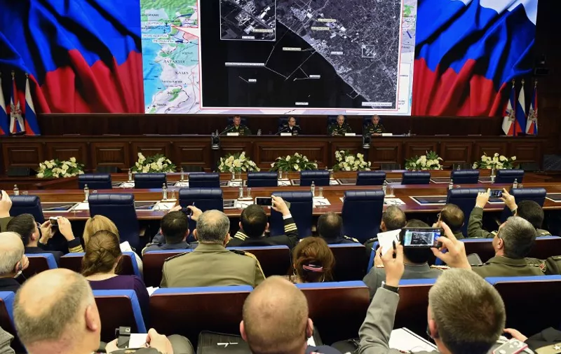 Russia's top military officials hold a press conference on the fight against terrorism in Syria at the National Defence Control Centre of the Russian Federation in Moscow on December 2, 2015. Russia's defence ministry on December 2 accused Turkish President Recep Tayyip Erdogan and his family of involvement in illegal oil trade with Islamic State jihadists, as a dispute rages over Ankara's downing of one of Moscow's warplanes. AFP PHOTO / VASILY MAXIMOV / AFP / VASILY MAXIMOV