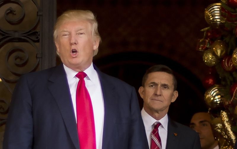 (FILES) In this file photo taken on December 21, 2016 US President-elect Donald Trump (L) stands with Trump National Security Adviser designate Lt. General Michael Flynn (R) at Mar-a-Lago in Palm Beach, Florida. - US President Donald Trump plans to pardon his former national security advisor Michael Flynn, who pleaded guilty in 2017 to lying to the FBI over his Russian contacts, US media reported on November 24, 2020. (Photo by JIM WATSON / AFP) / XGTY