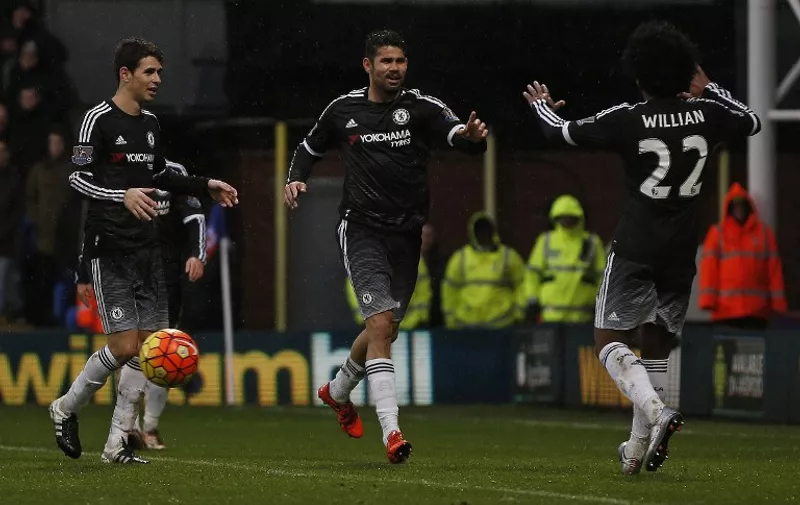 Chelsea's Brazilian-born Spanish striker Diego Costa (C) celebrates scoring his team's third goal with Chelsea's Brazilian midfielder Oscar (L) and Chelsea's Brazilian midfielder Willian during the English Premier League football match between Crystal Palace and Chelsea at Selhurst Park in south London on January 3, 2016. AFP PHOTO / ADRIAN DENNIS

RESTRICTED TO EDITORIAL USE. NO USE WITH UNAUTHORIZED AUDIO, VIDEO, DATA, FIXTURE LISTS, CLUB/LEAGUE LOGOS OR 'LIVE' SERVICES. ONLINE IN-MATCH USE LIMITED TO 75 IMAGES, NO VIDEO EMULATION. NO USE IN BETTING, GAMES OR SINGLE CLUB/LEAGUE/PLAYER PUBLICATIONS. / AFP / ADRIAN DENNIS