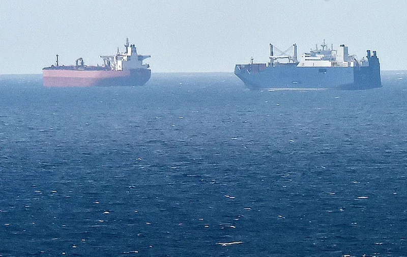 A picture taken on May 9, 2019 from northern port of Le Havre, shows Saudi cargo ship Bahri Yanbu (R) next to British crude oil tanker Nordic Space (L) waiting in the port of Le Havre. - French President defended his country's arms sales to Saudi Arabia and the United Arab Emirates on May 9, 2019 as campaigners focused attention on a new shipment set to leave from the northern port of Le Havre. Human rights groups have regularly denounced France for continuing to supply the Gulf states despite allegations of war crimes and civilian deaths during their military operations in neighbouring Yemen. (Photo by JEAN-FRANCOIS MONIER / AFP)