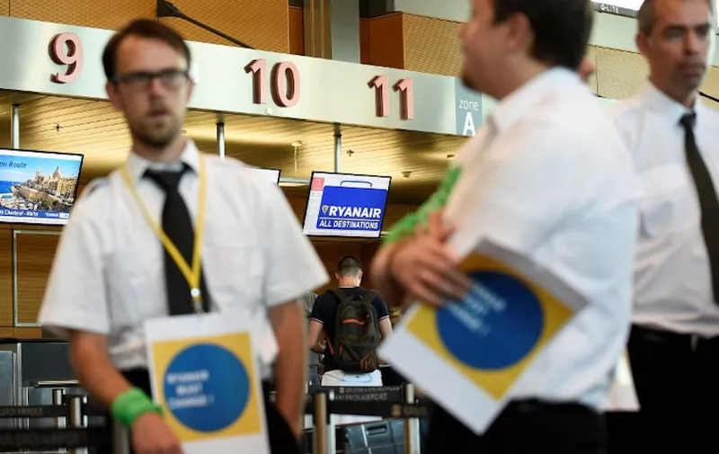Belgium-based Ryanair pilots gather at Charleroi Airport in Gosselies on August 10, 2018, as they take part in a European wide strike. 
Ryanair is bracing for mass travel disruptions as pilots across Europe begin a coordinated 24-hour strike to push their demands for better pay and conditions at the peak of the busy summer season. / AFP PHOTO / JOHN THYS