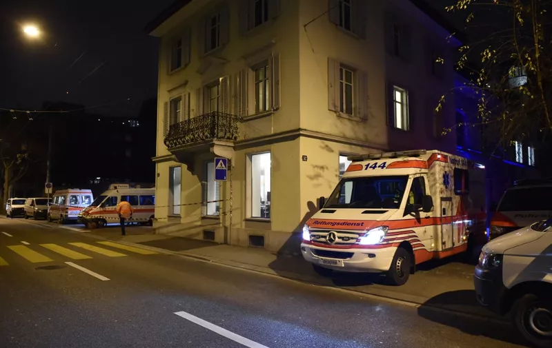 Ambulance and police cars are seen outside a Muslim prayer hall, central Zurich, on December 19, 2016, after three people were injured by gunfire. - Local media reported the incident occurred in the Muslim prayer hall near the city's railway station. Swiss media said the three wounded people, all adults, were found in the street where the prayer hall is located. The suspected assailant had fled the scene and police sealed off the area. (Photo by MICHAEL BUHOLZER / AFP)