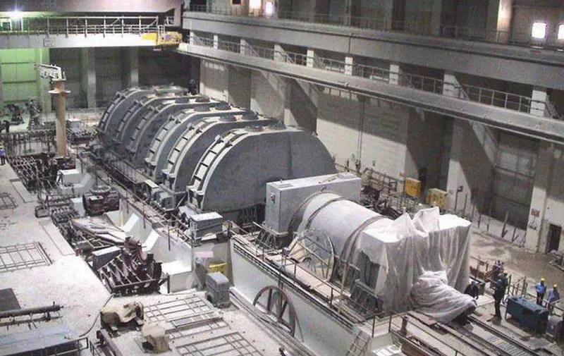 A handout picture released by Iran's Atomic Energy Organization 22 August 2004 shows a recent general view of the preliminary installation of a Turbo generator at the Islamic republic's first nuclear reactor, being constructed with Russian help in the Gulf port of Bushehr, some 1,300 kms south of Tehran. The plant will not enter service until 2006, a year later than originally planned, atomic energy officials revealed today. The new commissioning date of October 2006 was marked on a document shown at a press conference given by project manager Assadollah Saburi. Iran has repeatedly claimed its nuclear programme is entirely for civil purposes. AFP PHOTO/HO (Photo by IRAN ATOMIC ENERGY ORGANIZATION / AFP)