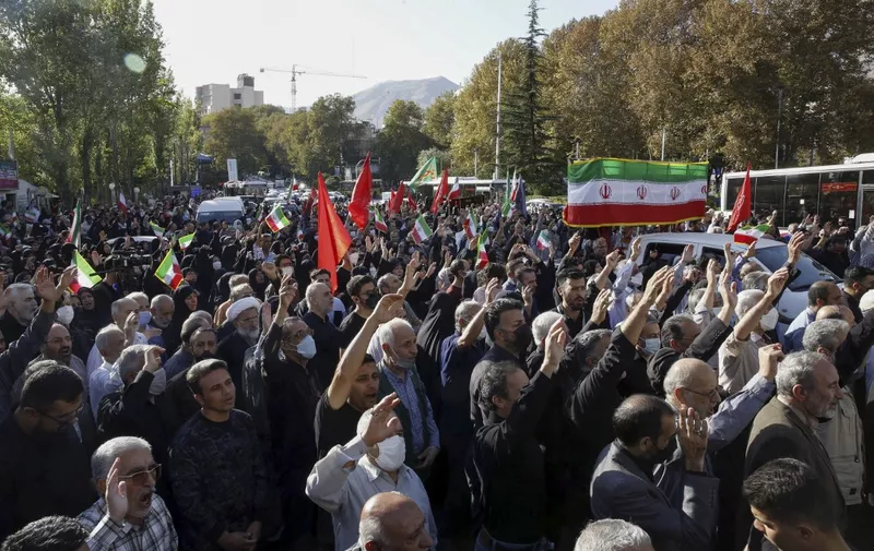 Iranians take part in a pro-government rally in Tajrish square north of Tehran, on October 5, 2022, condemning recent anti-government protests over the death of Mahsa Amini. - Amini, 22, was pronounced dead days after the notorious morality police detained the Iranian Kurdish woman in Tehran in Septembre 2022 for allegedly breaching the Islamic republic's strict dress code for women. Anger flared at her funeral and spread to become the biggest wave of protests to rock Iran in almost three years, despite the backlash by the security forces that has killed scores and seen hundreds arrested. (Photo by AFP)