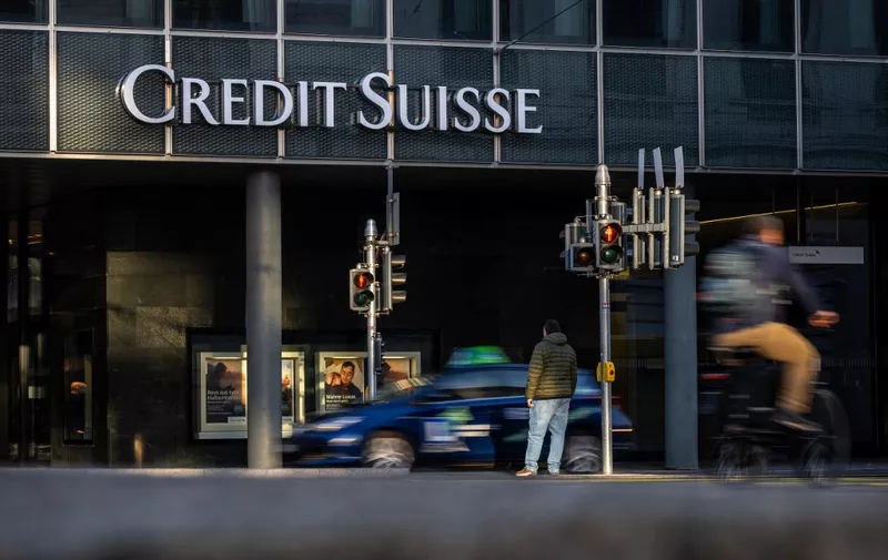 A picture taken on October 25, 2022 shows a sign of Switzerland's second-biggest bank Credit Suisse on a branch in Basel. - New Credit Suisse chief executive, faced with trying to turn around the beleaguered bank following multiple scandals, is set to unveil his strategic road map on October 27, 2022 as the pressure is on for Switzerland's second-biggest bank after investors saw their money go up in smoke due to the collapse in share prices. (Photo by Fabrice COFFRINI / AFP)