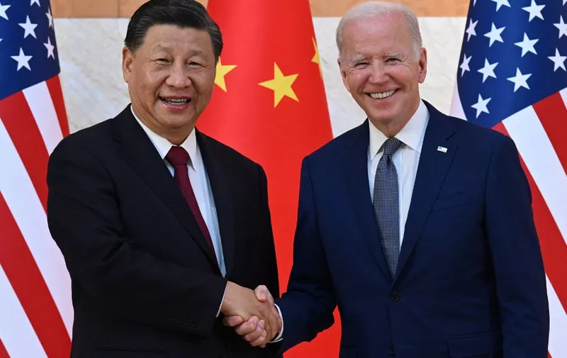 US President Joe Biden (R) and China's President Xi Jinping (L) shake hands as they meet on the sidelines of the G20 Summit in Nusa Dua on the Indonesian resort island of Bali on November 14, 2022. (Photo by SAUL LOEB / AFP)