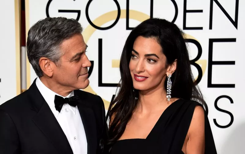 Actor George Clooney (L) and Amal Clooney arrive on the red carpet for the 72nd annual Golden Globe Awards, January 11, 2015 at the Beverly Hilton Hotel in Beverly Hills, California. AFP PHOTO/MARK RALSTON
