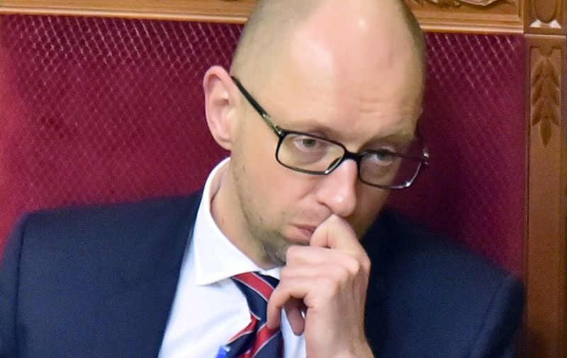 (FILES) This file photo taken on February 16, 2016 shows Ukrainian Prime Minister Arseniy Yatsenyuk reacting prior to the no confidence vote at the parliament in Kiev on February 16, 2016.  
Ukraine's Prime Minister Arseniy Yatsenyuk said in a televised address on April 10, 2016 that he  has decided to resign, less than two months after surviving a no-confidence vote in parliament. "I decided to step down from the post of prime minister of Ukraine," he said in a message aired by Ukrainian channels, Interfax news agency reported.
 / AFP PHOTO / SERGEI SUPINSKY