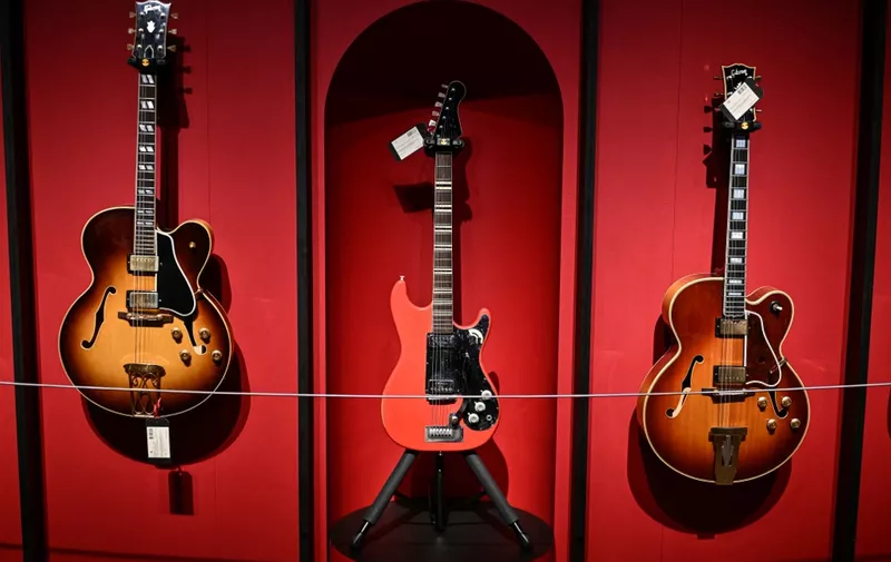 (From L) A Gibson Incorporated Kalamazoo Michigan 1958, an Hofner Bubenreuth Germany Circa 1963 and a Gibson Incorporated Kalamazoo Michigan circa 1970-1972 guitars are displayed during the pre-sale exhibition of guitars from the personal collection of British singer and guitarist Mark Knopfler at Christies auction house in London, on January 26, 2024. (Photo by Ben Stansall / AFP)