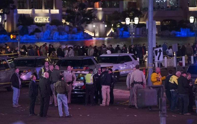 Police and local officials investigate a part of the Las Vegas Strip after a car ran into a group of pedestrians between Planet Hollywood, where the Miss Universe pageant took place, and the Paris Las Vegas Hotel in Las Vegas, Nevada, on December 20, 2015. At least one person has died and more than 37 have been hurt after a car ran into a group of pedestrians on the bustling Las Vegas Strip on December 20, police said, adding the driver was in custody.     AFP PHOTO / VALERIE MACON / AFP / VALERIE MACON