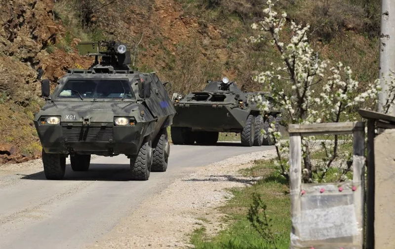 Police armed personnel carriers ride down a road to the village of Goshince, from where police officers were taken hostage overnight, north of the capital Skopje on April 21, 2015. About 40 armed men wearing uniforms of a disbanded ethnic Albanian guerrilla army from Kosovo took several police officers hostage in northern Macedonia overnight, Macedonian [&hellip;]