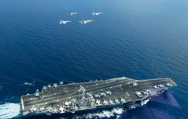 This May 10, 2015 US Navy handout photo shows two F/A-18 Super Hornets(L and R) and two Royal Malaysian Air Force SU-30MKM/Flanker H, flying above the aircraft carrier USS Carl Vinson (CVN 70) operating in the South China Sea during a bi-lateral exercise aimed at promoting interoperability with the Malaysian Royal Military. The Carl Vinson Strike Group is deployed to the U.S. 7th Fleet area of operations supporting security and stability in the Indo-Asia-Pacific region. AFP PHOTO / HANDOUT / US NAVY / LT. JONATHAN PFAFF          == RESTRICTED TO EDITORIAL USE / MANDATORY CREDIT: "AFP PHOTO / HANDOUT / US NAVY / LT. JONATHAN PFAFF  "/ NO MARKETING / NO ADVERTISING CAMPAIGNS / NO A LA CARTE SALES / DISTRIBUTED AS A SERVICE TO CLIENTS ==