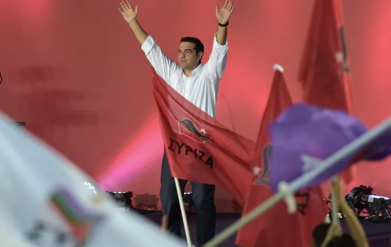 TOPSHOTS
Radical left Syriza leader Alexis Tsipras greets his supporters during the party's main pre-election rally in central Athens Syntagma square on September 18, 2015. Final polls before Sunday's key Greek election gave a slim lead to radical left former prime minister Alexis Tsipras over his conservative rival.  AFP PHOTO / ARIS MESSINIS
