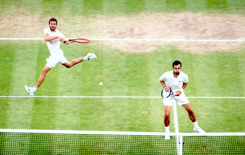 Tennis - Wimbledon - All England Lawn Tennis and Croquet Club, London, Britain - July 10, 2021  Croatia's Nikola Mektic and Mate Pavic in action during the men's doubles final against Spain's Marcel Granollers and Argentina's Horacio Zeballos REUTERS/Paul Childs