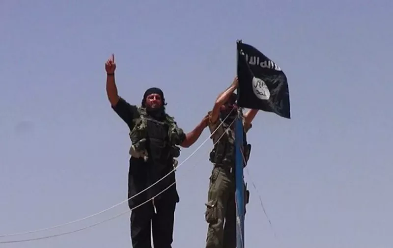 An image made available by the jihadist Twitter account Al-Baraka news on June 11, 2014 allegedly shows militants of the jihadist group Islamic State of Iraq and the Levant (ISIL) hanging the Islamic Jihad flag on a pole at the top of an ancient military fort after they cut a road through the Syrian-Iraqi border between the Iraqi Nineveh province and the Syrian town of Al-Hasakah. AFP PHOTO / HO / ALBARAKA NEWS
=== RESTRICTED TO EDITORIAL USE - MANDATORY CREDIT "AFP PHOTO / HO / ALBARAKA NEWS" - NO MARKETING NO ADVERTISING CAMPAIGNS - DISTRIBUTED AS A SERVICE TO CLIENTS FROM ALTERNATIVE SOURCES, AFP IS NOT RESPONSIBLE FOR ANY DIGITAL ALTERATIONS TO THE PICTURE'S EDITORIAL CONTENT, DATE AND LOCATION WHICH CANNOT BE INDEPENDENTLY VERIFIED === / AFP PHOTO / ALBARAKA NEWS / -