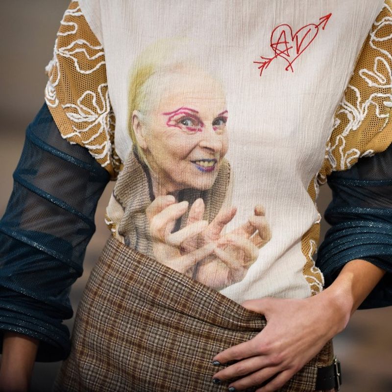 A model presents a creation with the face of the late fashion designer Vivienne Westwood during Vivienne Westwood Womenswear Fall-Winter 2023-2024 collection during Paris Fashion Week at the Hotel de la Marine, on Place de la Concorde  in Paris, on March 4, 2023. (Photo by JULIEN DE ROSA / AFP)