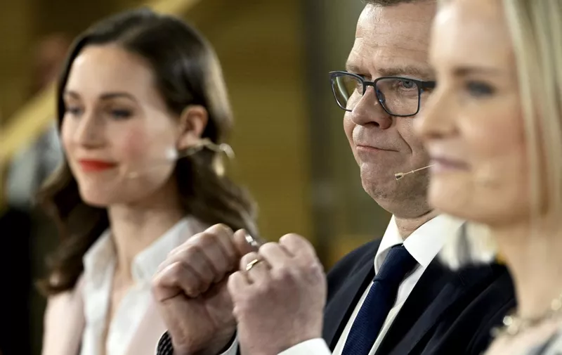 (R to L) The Finns Party chair Riikka Purra, National Coalition Party chair Petteri Orpo and Social Democratic Party SDP chair and Finnish Prime Minister Sanna Marin react during a live broadcast from the Pikkuparlamentti following the Finnish parliamentary elections, on April 2, 2023, in Helsinki. - Finnish public broadcaster Yle predicted the centre-right National Coalition Party would win 48 of the 200 seats in parliament, ahead of the Finns Party with 46 seats and the Social Democrats with 43. (Photo by Heikki Saukkomaa / Lehtikuva / AFP) / Finland OUT