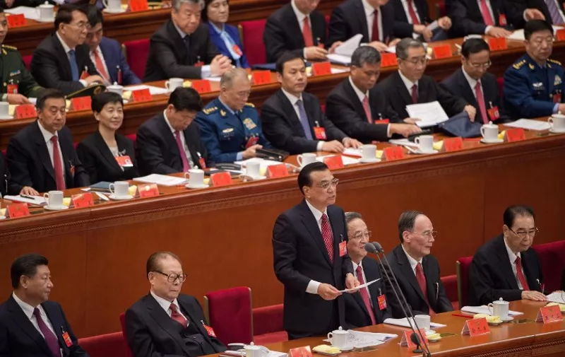 China's President Xi Jinping (front L) and former president Jiang Zemin (front 2nd L) listen to Premier Li Keqiang (front C) during the opening session of the Chinese Communist Party's Congress at the Great Hall of the People in Beijing on October 18, 2017.
President Xi Jinping declared China is entering a "new era" of challenges and opportunities on October 18 as he opened a Communist Party congress expected to enhance his already formidable power. / AFP PHOTO / Nicolas ASFOURI