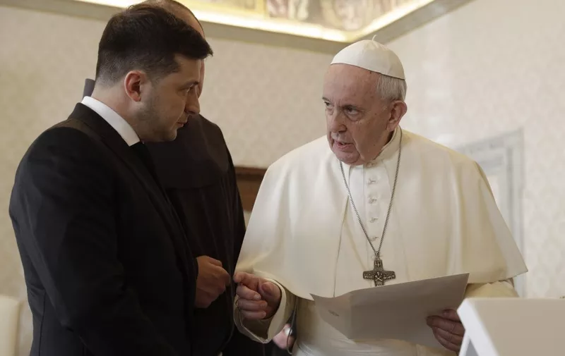Pope Francis exchanges gift with Ukrainian President Volodymyr Zelensky (L) during a private audience at the Vatican on February 8, 2020. (Photo by Gregorio Borgia / POOL / AFP)
