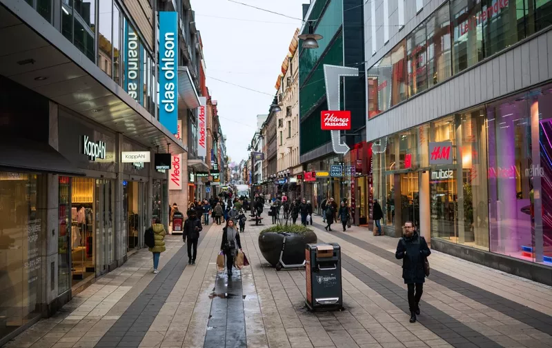 People visit one of Stockholm's busiest shopping streets on February 4, 2022, during the ongoing coronavirus COVID-19 pandemic. (Photo by Jonathan NACKSTRAND / AFP)