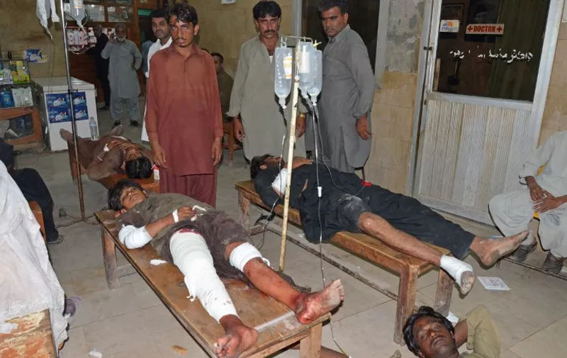 Injured suicide blast victims lie on hospital tables after a suicide blast targeting a Shiites procession in the southern Pakistani city of Jacobabad on October 23, 2015. At least 15 people were killed and dozens injured in a suspected suicide blast targeting Shiites in the southern Pakistani city of Jacobabad Friday, police and hospital officials said. AFP PHOTO / FIDA HUSSAIN