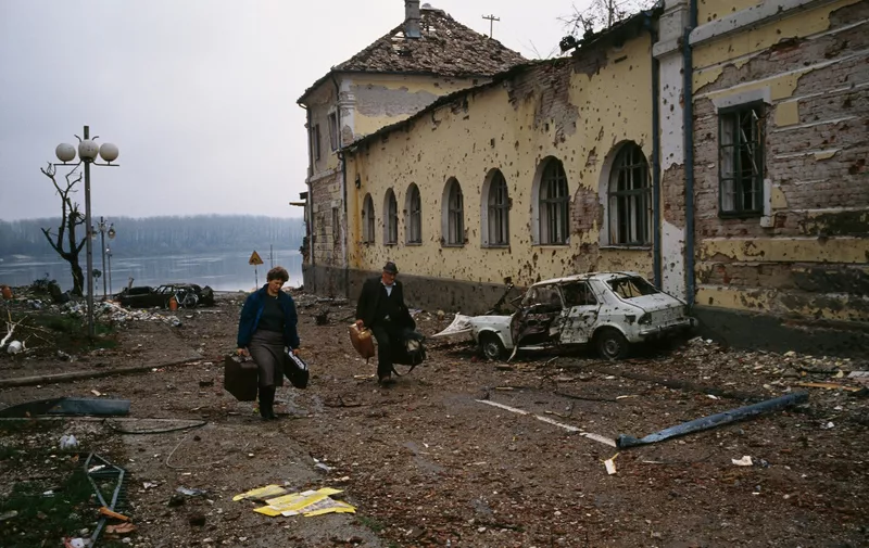 A middle-aged Croatian couple flees the ruined city of Vukovar past bombed buildings riddled with bullet holes and streets filled with rubble after a three-month battle between the Croatian armed forces and the Yugoslavian Federal Army in Vukovar. The Yugoslavian Federal Army completely destroyed the Croatian city and killed thousands of civilians., Image: 16127894, License: Rights-managed, Restrictions: Content available for editorial use, pre-approval required for all other uses.
This content may not be materially modified or used in composite content., Model Release: no, Credit line: Profimedia, Corbis