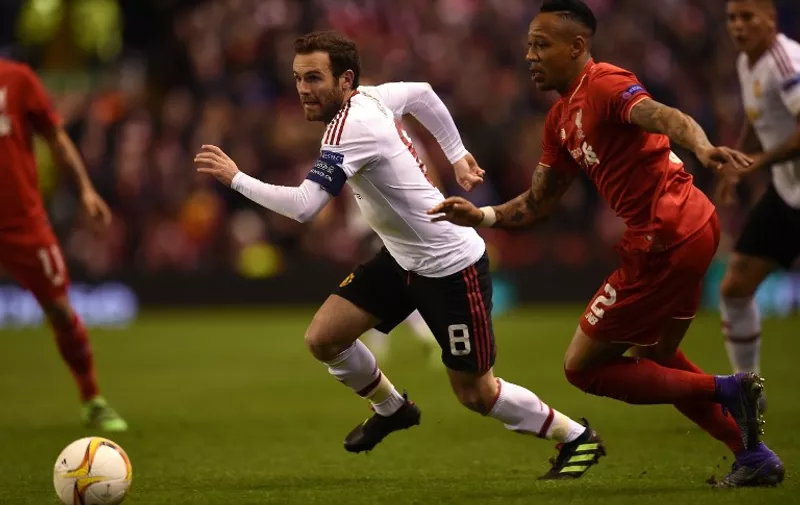 Liverpool's English defender Nathaniel Clyne (R) vies with Manchester United's Spanish midfielder Juan Mata during the UEFA Europa League round of 16, first leg football match between Liverpool and Manchester United at Anfield in Liverpool, northwest England on March 10, 2016. / AFP / PAUL ELLIS