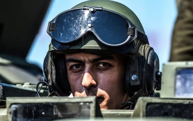 A Turkish army tank driver takes part in a military parade marking the 93rd anniversary of Victory Day in Istanbul on August 30, 2015. Turkey commemorates the anniversary of the day in 1922 that marked the end of Turkey's independence war with a victory over Greek troops in Anatolia. AFP PHOTO / OZAN KOSE / AFP / OZAN KOSE