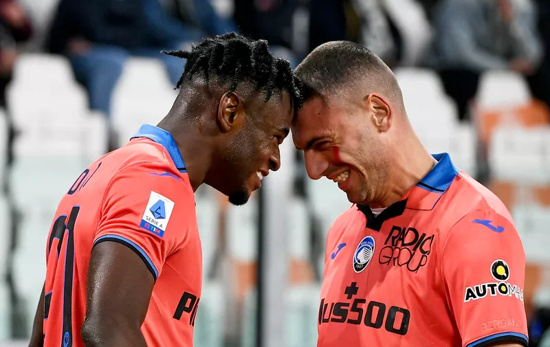 Atalanta's Duvan Zapata, left, celebrates with Merih Demiral after scoring his side's opening goal during the Serie A soccer match between Juventus and Atalanta, at the Allianz stadium in Turin, Italy, Saturday, Nov. 27, 2021. (Fabio Ferrari/LaPresse via AP)