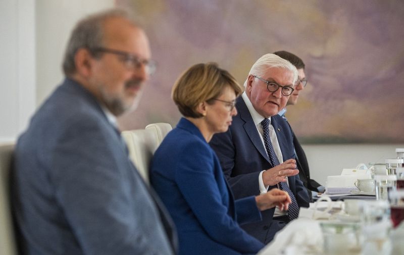 (From L) President of the German Teachers Association Heinz-Peter Meidinger, wife of the German President Elke Buedenbender, German President Frank-Walter Steinmeier, and physicist and doctor Kai Ueltzehoeffer, discuss current restrictions due to the Coronavirus Covid19 pandemic, during a meeting at the presidential palace in Berlin on September 22, 2020. - Steinmeier invited proponents and critics of the current restrictions for coffee at the palace to consult with them over the short and long term effects of pandemic-related policies conducted by the government. (Photo by John MACDOUGALL / AFP)