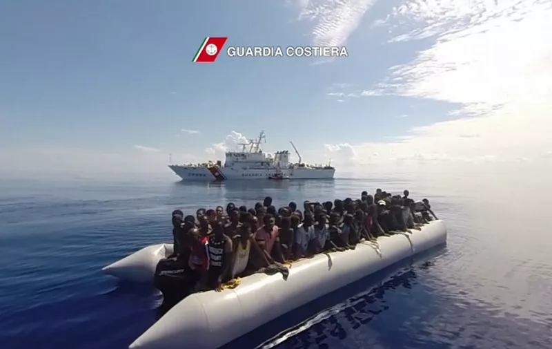 In this video grab released by the Italian Coast Guards (Guardia Costiera) on September 29, 2015 migrants sit in boat during a rescue operation, yesterday, off the coast of Sicily as part of the Frontex-coordinated Operation Triton. The Italian coastguard said it had coordinated the rescue Monday of 1,151 migrants in 11 separate operations off the Libyan coast. In the biggest operation, a coastguard ship picked up 441 people from four inflatable boats, it said in a statement.  AFP PHOTO / HO
= RESTRICTED TO EDITORIAL USE - MANDATORY CREDIT "AFP PHOTO / GUARDIA COSTIERA" - NO MARKETING NO ADVERTISING CAMPAIGNS - DISTRIBUTED AS A SERVICE TO CLIENTS = / AFP / GUARDIA COSTIERA / -