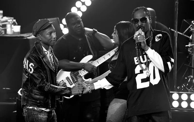 BURBANK, CA - MAY 11: (EDITORS NOTE: This image was processed using digital filters.) Producer/Recording artist Pharrell Williams (L) and rapper Snoop Dogg perform onstage during Snoop Dogg Live on the Honda Stage at iHeartRadio Theater on May 11, 2015 in Burbank, California.   Kevin Winter/Getty Images for iHeartMedia/AFP
